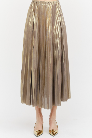 A metallic gold pleated midi skirt worn by a model, paired with gold pointed-toe heels, shown against a plain white studio background.